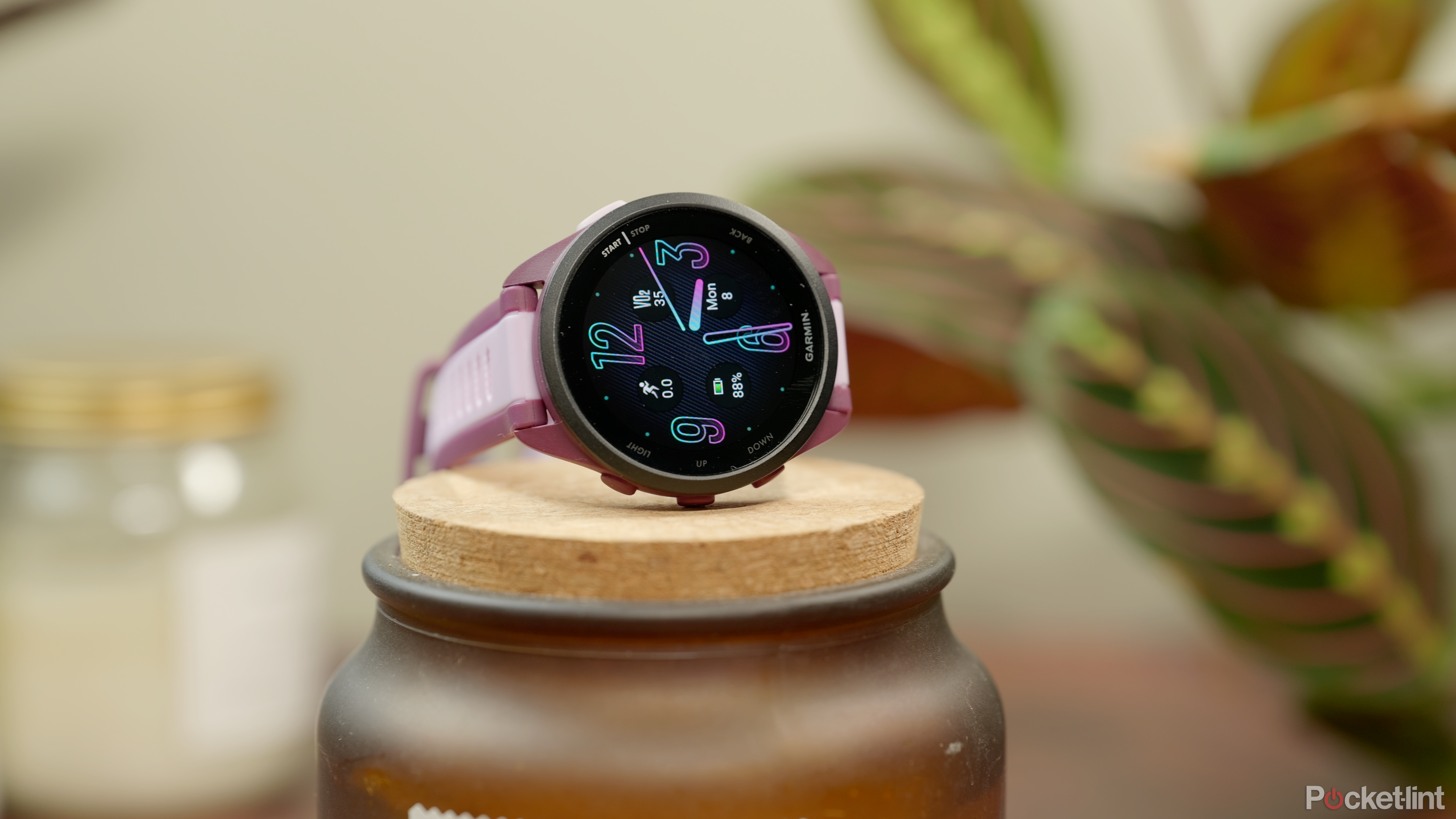 Garmin Forerunner 165 stands on a jar