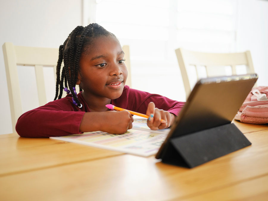 a girl attending school on an ipad